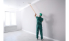 a man painting a ceiling with a extension pole roller