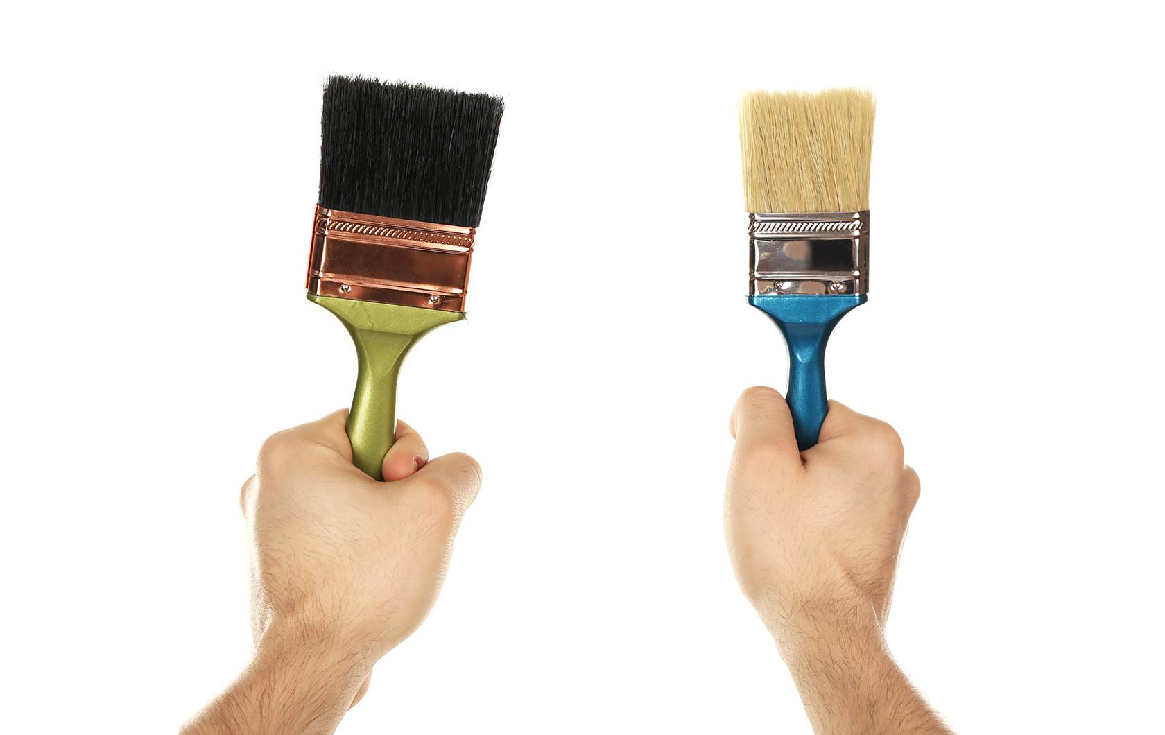 two hands holding paint brushes