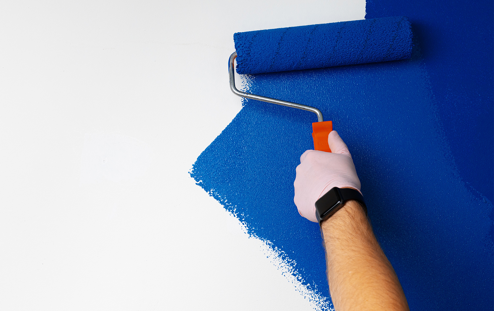 using a paint roller to paint blue paint